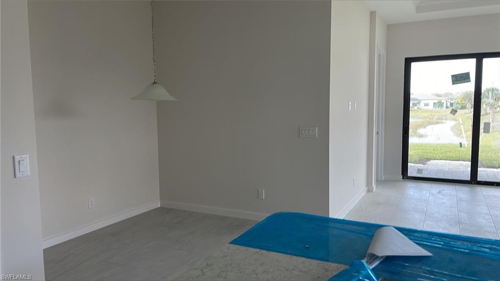 14557 Kingfisher Loop Naples, FL 34120 - Photo 7 of 27 an empty room with wooden floor and windows