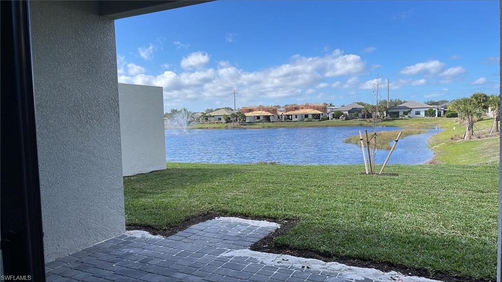 14557 Kingfisher Loop Naples, FL 34120 - Photo 9 of 27 a view of a lake with a building in the background