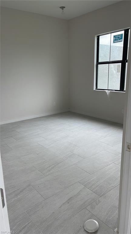 14557 Kingfisher Loop Naples, FL 34120 - Photo 10 of 27 a view of an empty room with a window