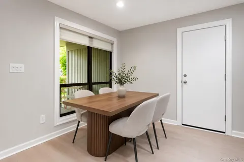 a view of a dining room with furniture and chandelier