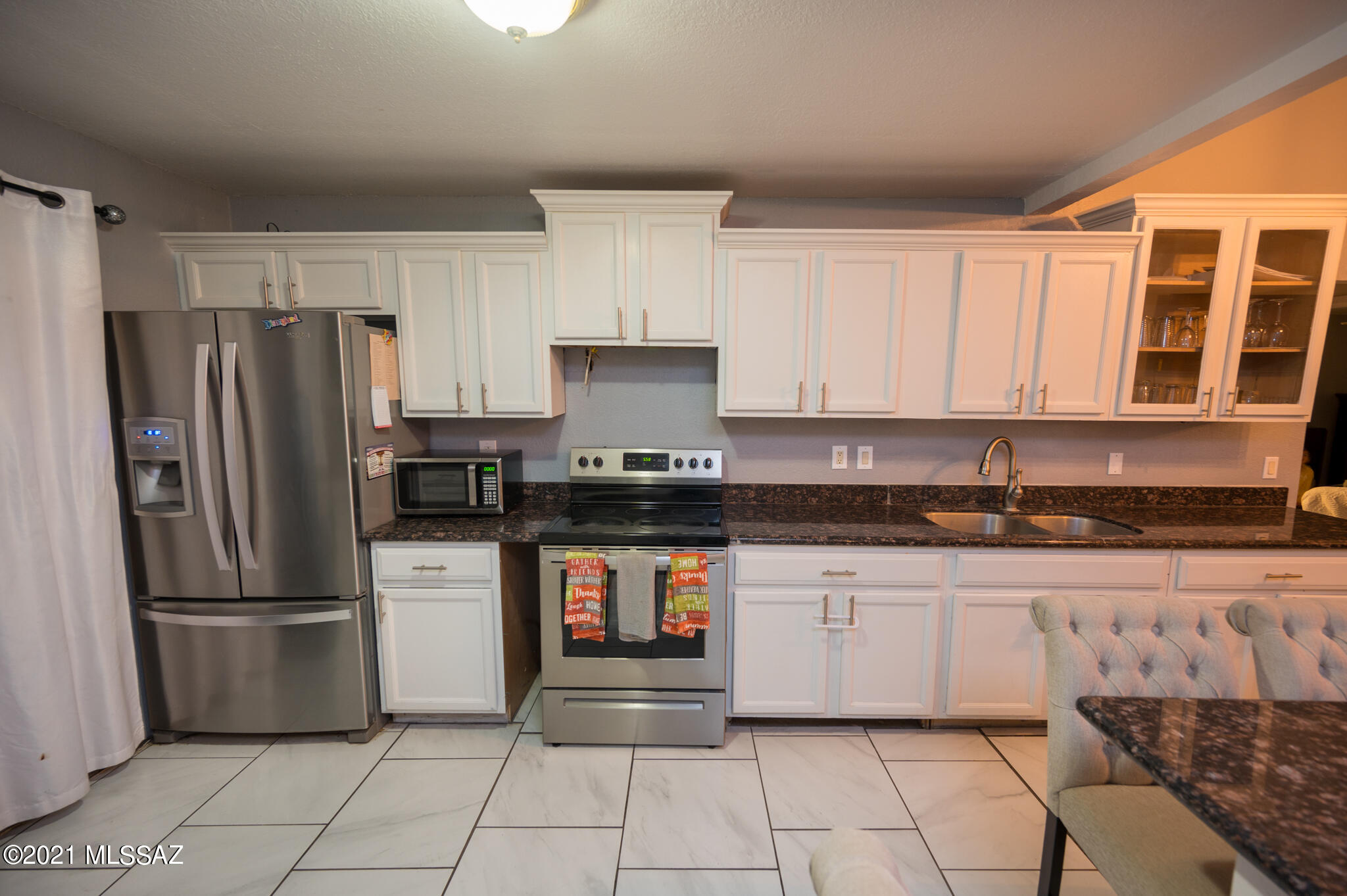 577 Camino Lito Galindo Rio Rico, AZ 85648 - Photo 9 of 19 a kitchen with granite countertop a refrigerator and a sink