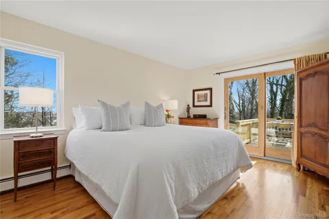 a bedroom with a large bed and a large window with outer view