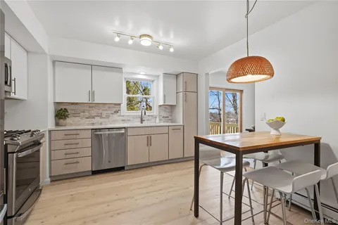 a kitchen with a table a sink cabinets and appliances