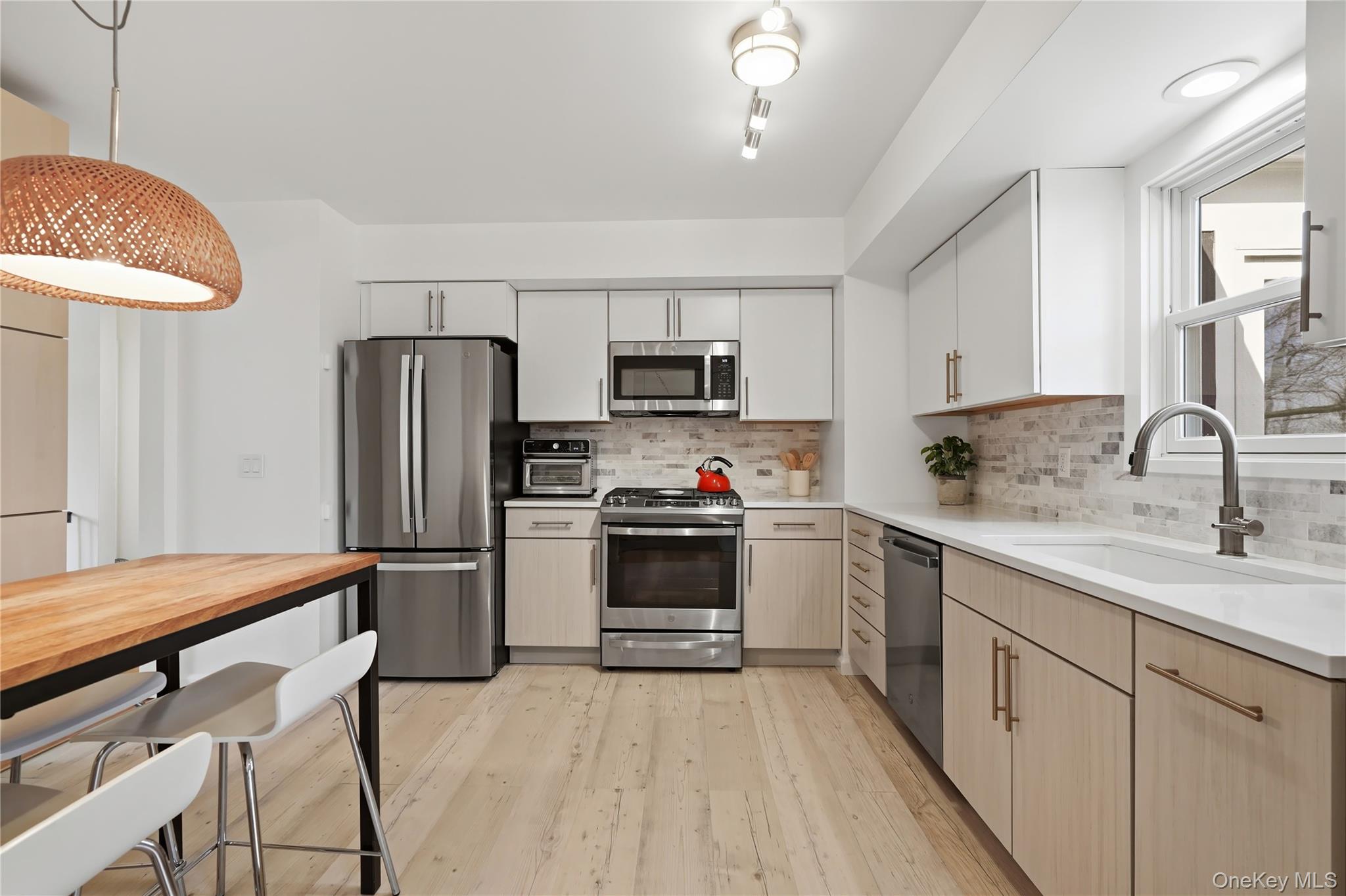 166 Highview Street Mamaroneck, NY 10543 - Photo 4 of 30 a kitchen with stainless steel appliances a stove refrigerator sink and microwave