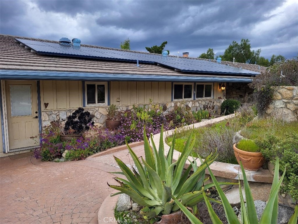 a front view of house with a garden