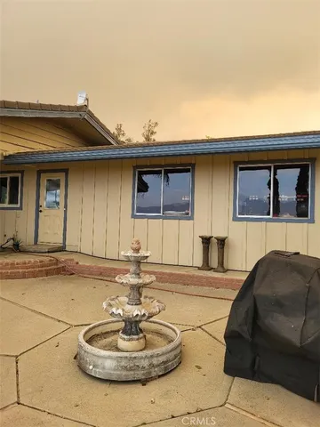 a living room with furniture a mirror and a clock