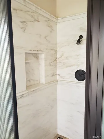 a white toilet sitting next to a shower