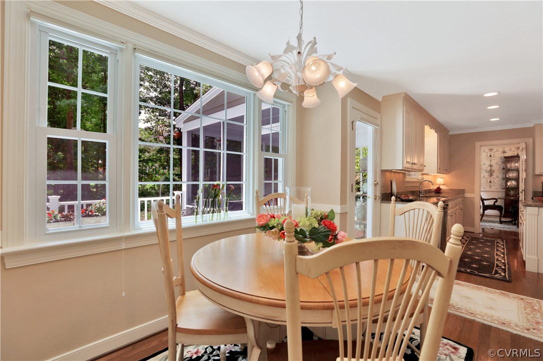 14301 Newgate Road Midlothian, VA 23113 - Photo 13 of 37 a view of a dining room with furniture large windows and wooden floor