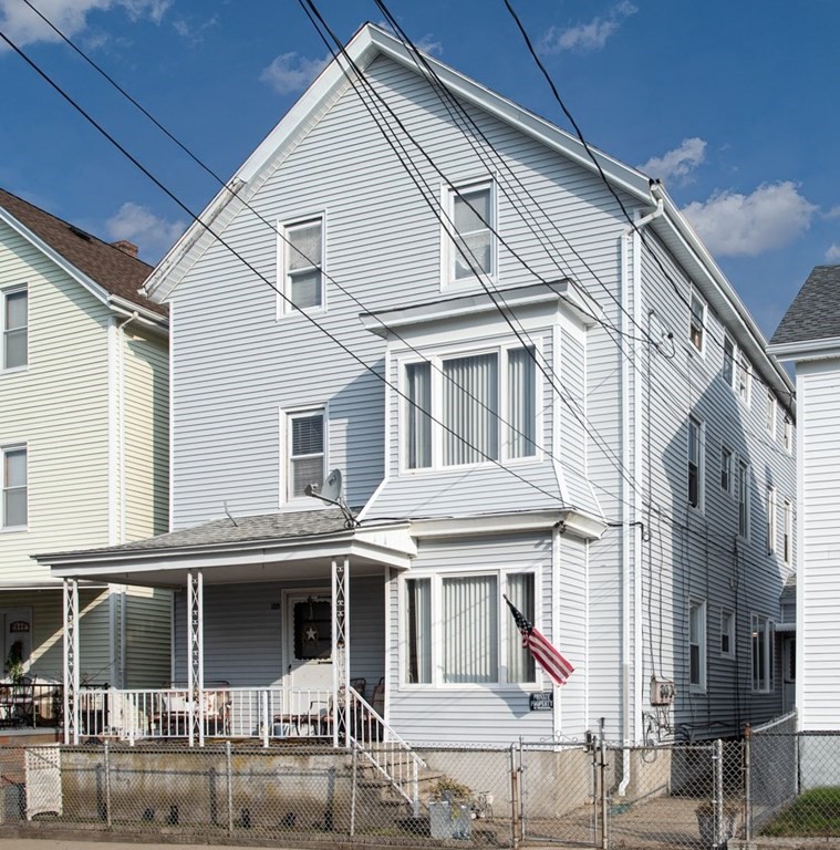 a front view of a residential apartment building with a yard