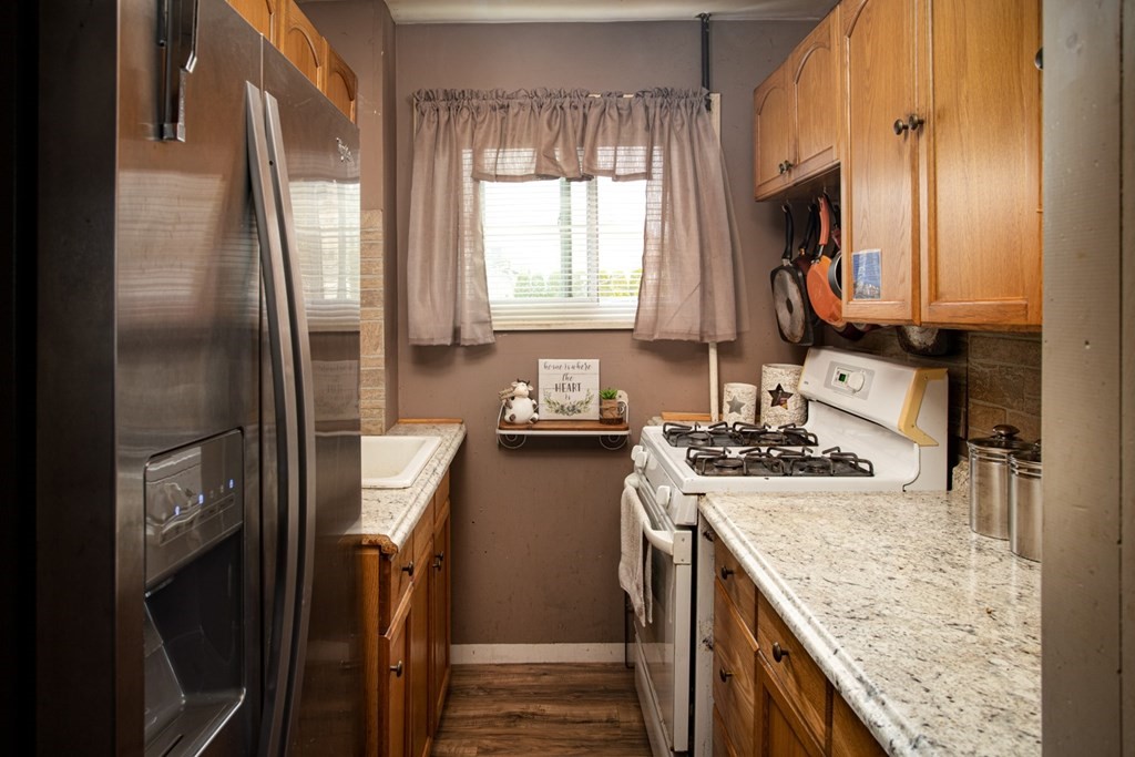 552 Palmer Street Fall River, MA 02721 - Photo 13 of 15 a kitchen with a stove a sink and a refrigerator