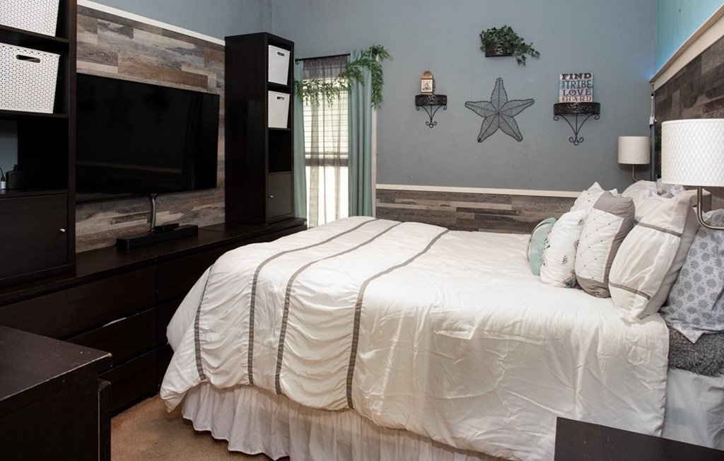 552 Palmer Street Fall River, MA 02721 - Photo 5 of 15 a bedroom with a bed and a flat screen tv