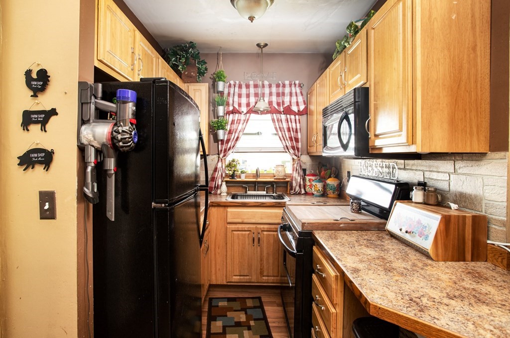 552 Palmer Street Fall River, MA 02721 - Photo 9 of 15 a kitchen with stainless steel appliances granite countertop a refrigerator a stove and a sink