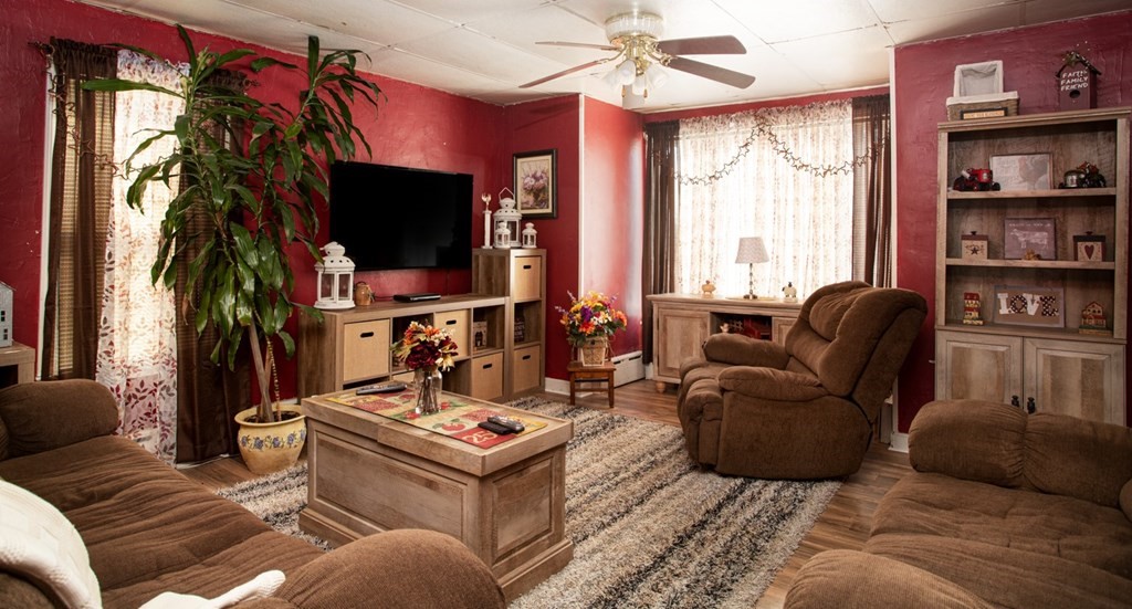 552 Palmer Street Fall River, MA 02721 - Photo 10 of 15 a living room with furniture a flat screen tv and a large window