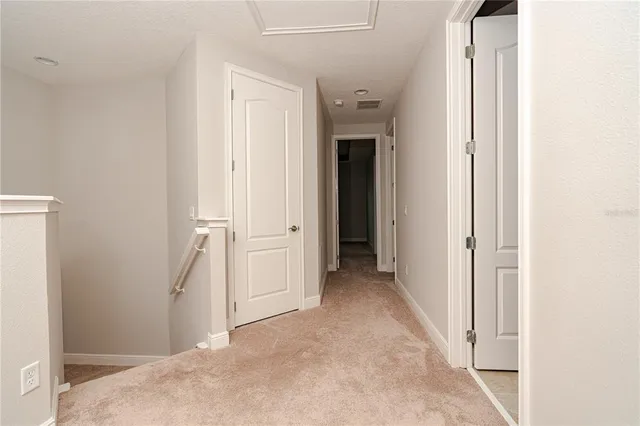a view of a hallway with hallway and closet