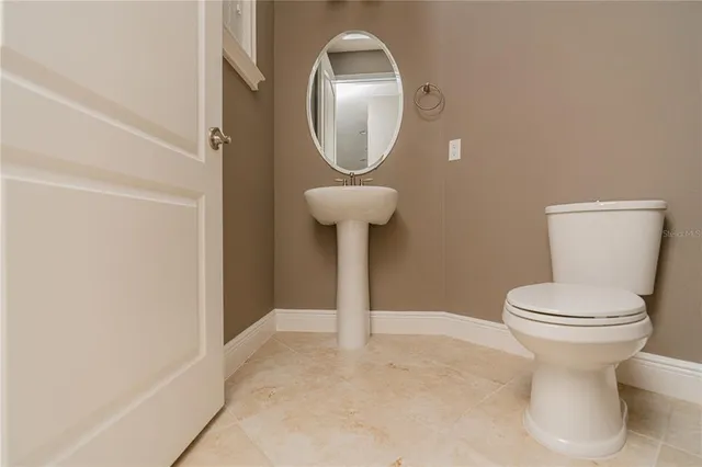 a white toilet sitting next to a bathroom sink
