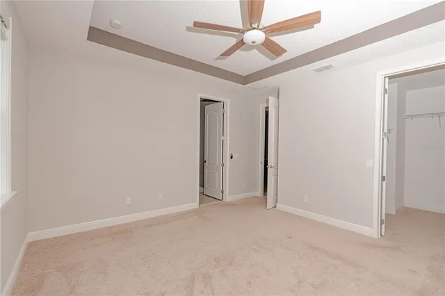 a bathroom with a granite countertop shower sink vanity and mirror