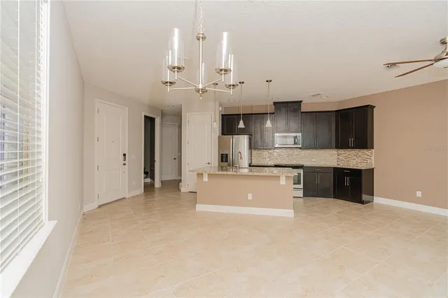 a large kitchen with kitchen island a sink stainless steel appliances and cabinets