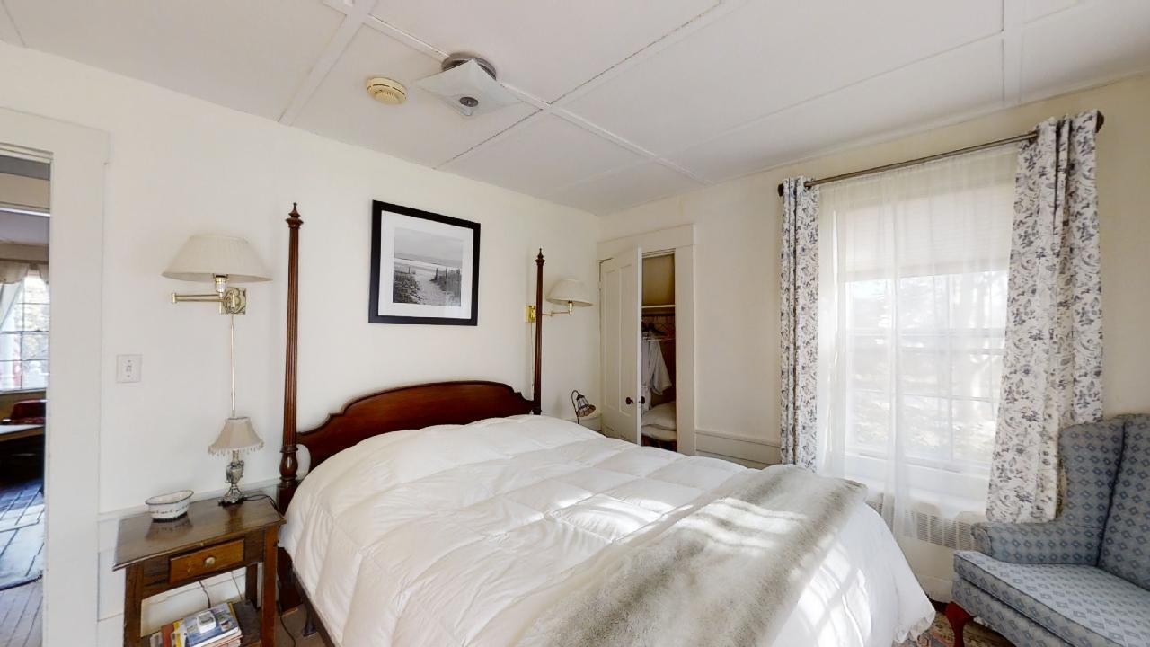 152 Whig Street Dennis, MA 02638 - Photo 15 of 35 a bedroom with a bed and a painting on the wall