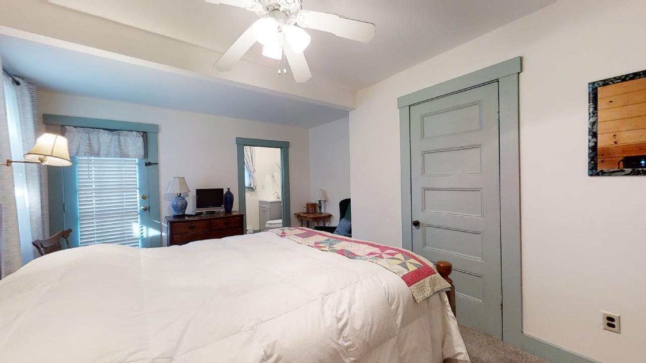 152 Whig Street Dennis, MA 02638 - Photo 18 of 35 a bedroom with a bed and a chandelier