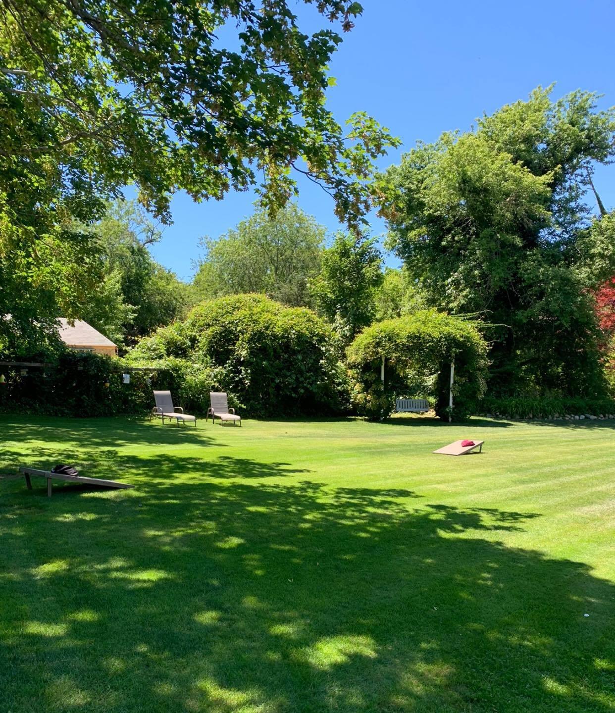 152 Whig Street Dennis, MA 02638 - Photo 2 of 35 a backyard of a house with a yard and outdoor seating