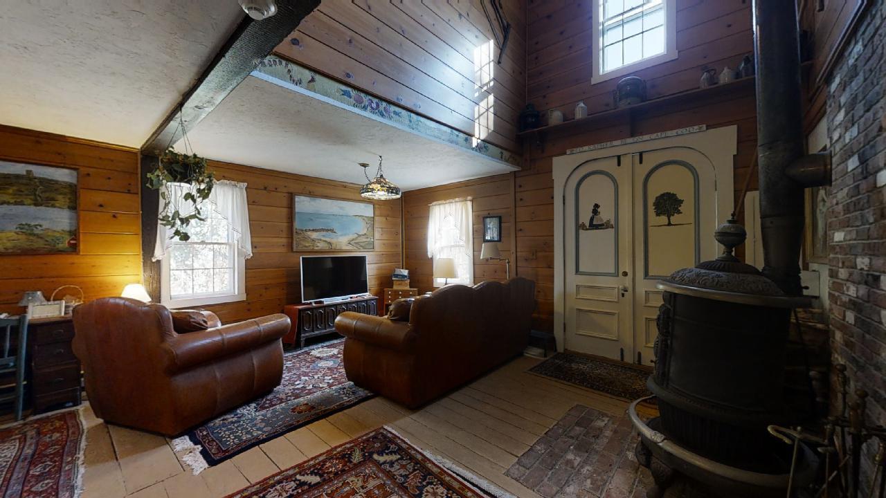 152 Whig Street Dennis, MA 02638 - Photo 27 of 35 a living room with furniture a fireplace and a flat screen tv