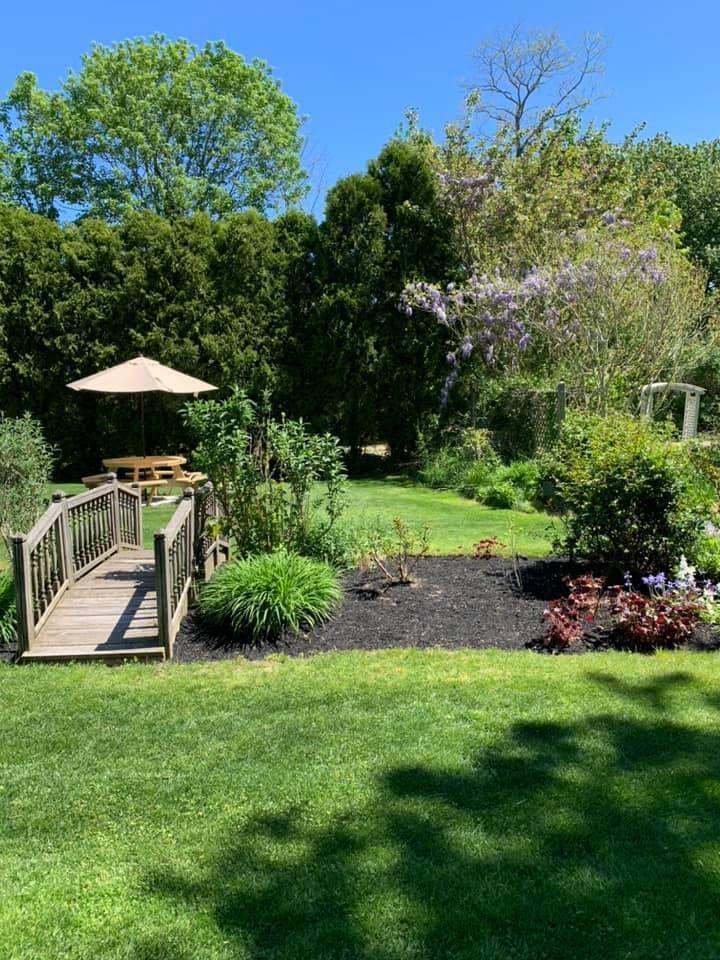 152 Whig Street Dennis, MA 02638 - Photo 31 of 35 a view of a backyard with chairs and a garden