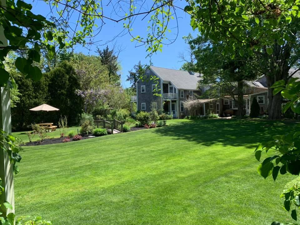 152 Whig Street Dennis, MA 02638 - Photo 33 of 35 a view of a house with a big yard and large trees