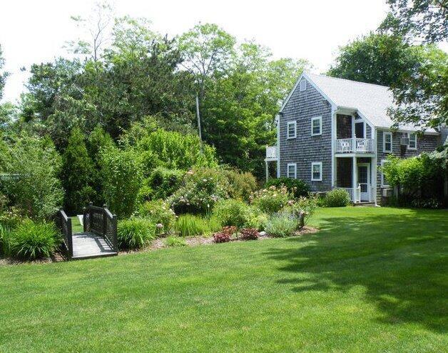 152 Whig Street Dennis, MA 02638 - Photo 34 of 35 a front view of a house with a yard and trees