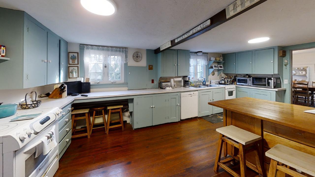 152 Whig Street Dennis, MA 02638 - Photo 10 of 35 a kitchen with a table chairs stove and cabinets