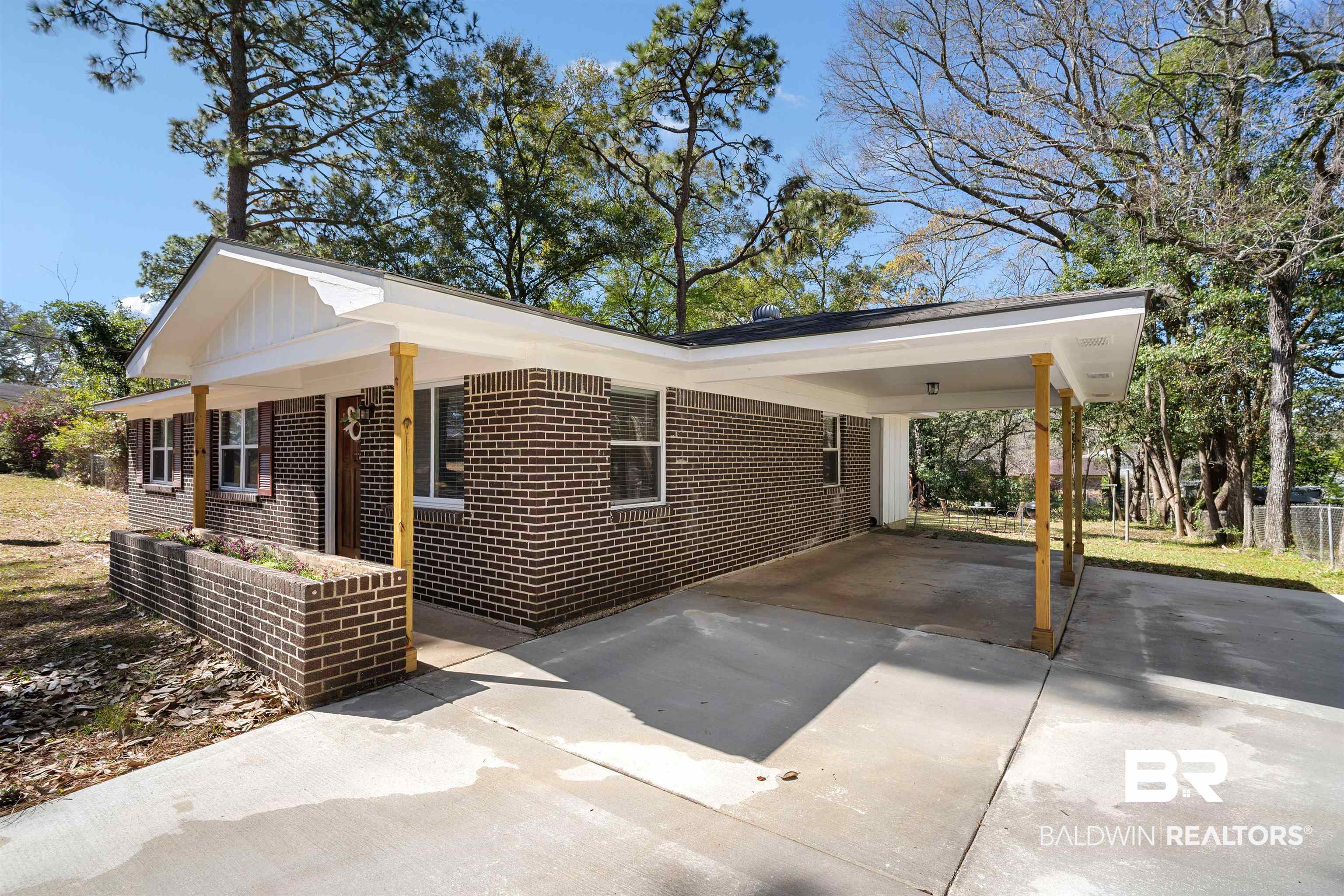 672 Tarawa Drive Mobile, AL 36609 - Photo 24 of 26 View of home's exterior with brick siding, concrete driveway, and a carport
