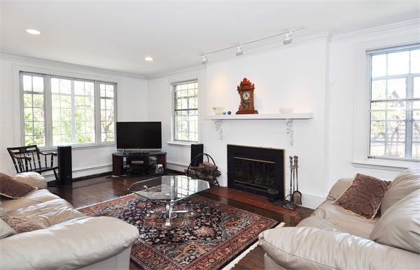 80 Arnold Road Newton, MA 02459 - Photo 3 of 11 a living room with furniture a flat screen tv and a fireplace