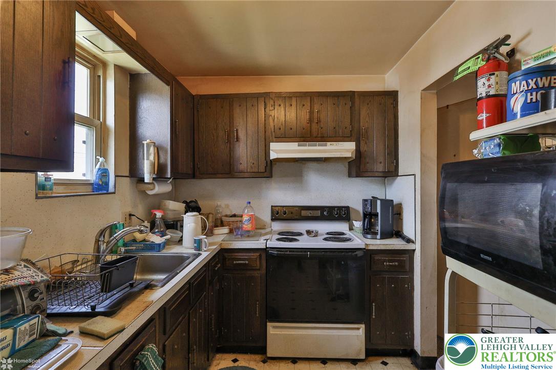 802 West Berwick Street Easton, PA 18042 - Photo 39 of 54 a kitchen with stainless steel appliances granite countertop a stove a sink and a microwave