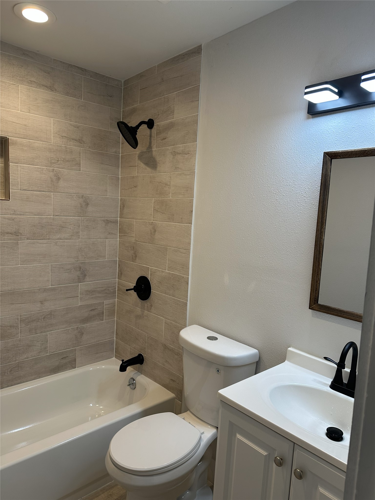 804 Ward Street Rosenberg, TX 77471 - Photo 8 of 9 a bathroom with a sink a toilet and a bathtub