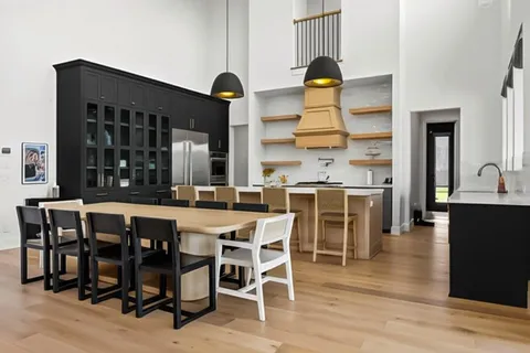 a dining table with chairs and wooden floor