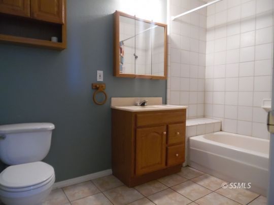 1612 South Yorktown Street Ridgecrest, CA 93555 - Photo 13 of 26 a bathroom with a sink a toilet and bathtub
