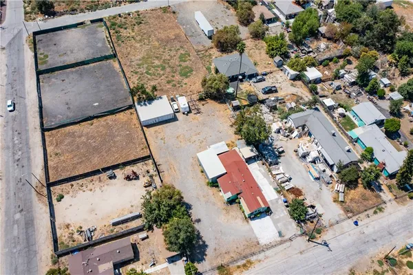 an aerial view of a house with a yard and parking spaces
