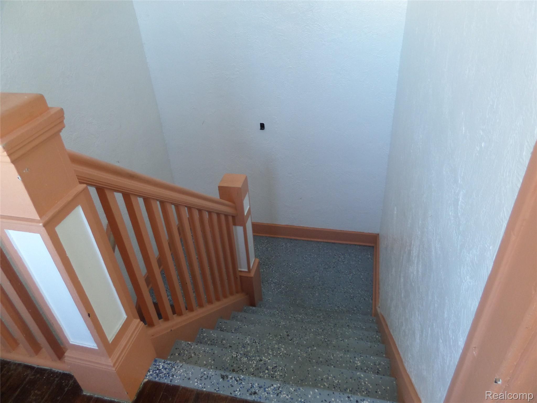 384 Perry Street Pontiac, MI 48342 - Photo 20 of 28 Stairs featuring baseboards and a textured wall