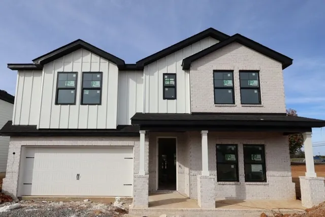a front view of a house with a garage