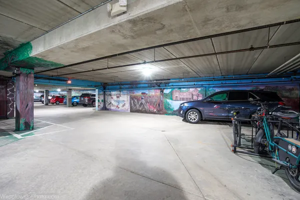 a view of parking garage with cars