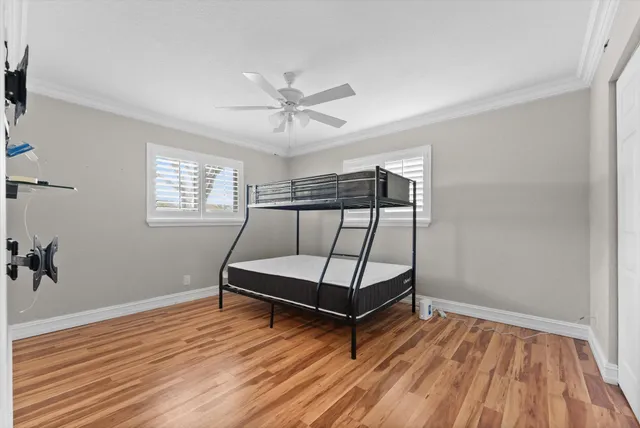 a bedroom with bunk bed and a window