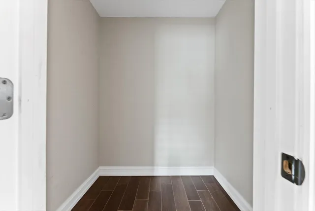 a view of a room with wooden floor