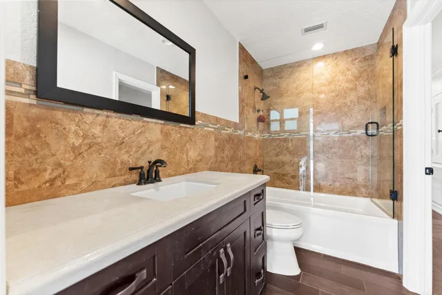 a bathroom with a sink a toilet and a bathtub