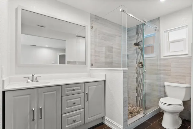 a bathroom with a sink toilet and shower