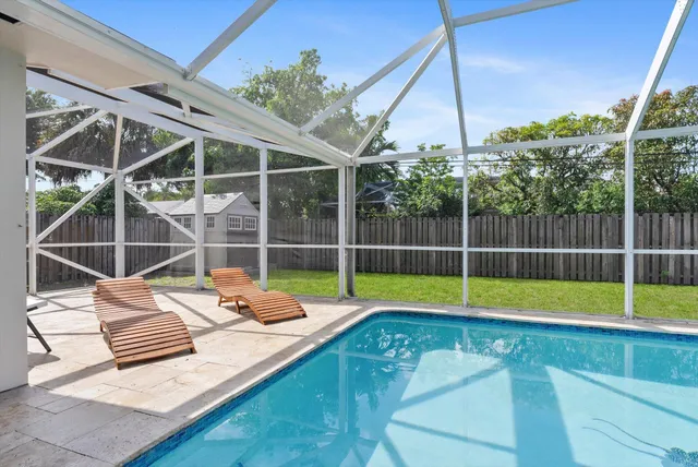 a view of a backyard with swimming pool