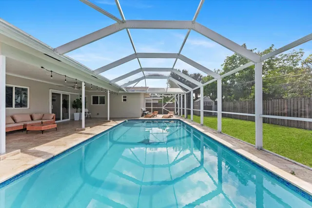 a view of swimming pool with a lounge chairs