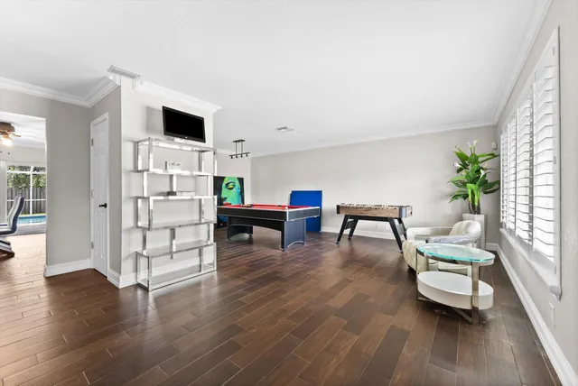 a living room with furniture and wooden floor
