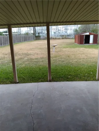 a view of a backyard of a house with a porch