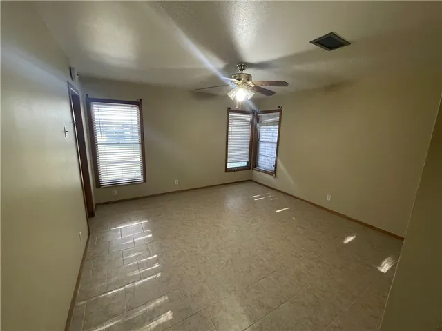 a view of an empty room with windows