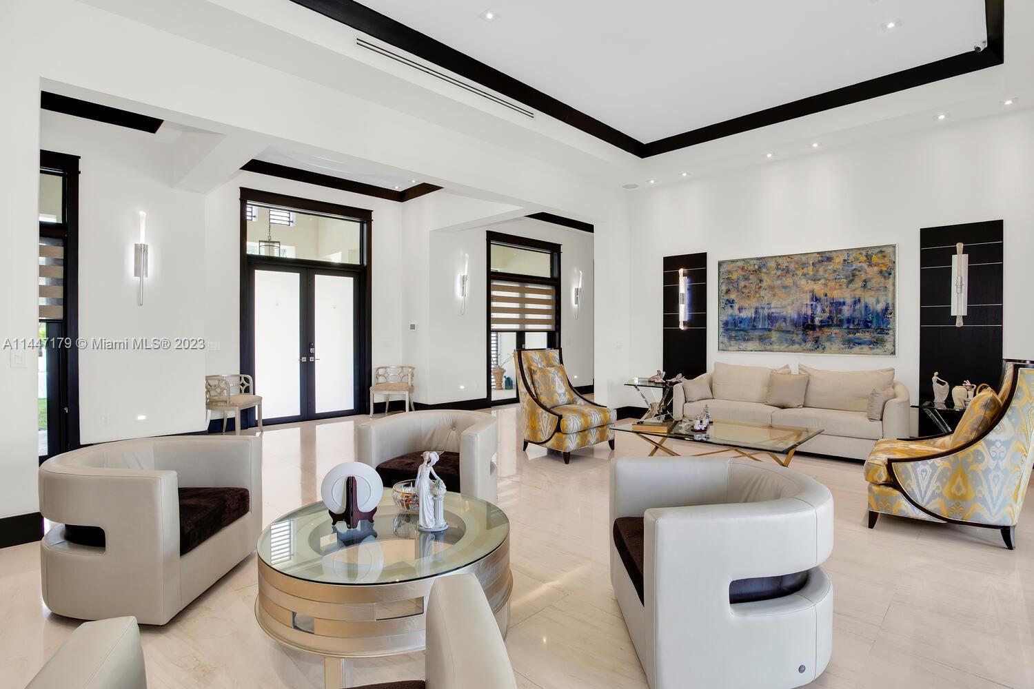 11880 Southwest 47th Street Miami, FL 33175 - Photo 11 of 61 a living room with furniture and a flat screen tv