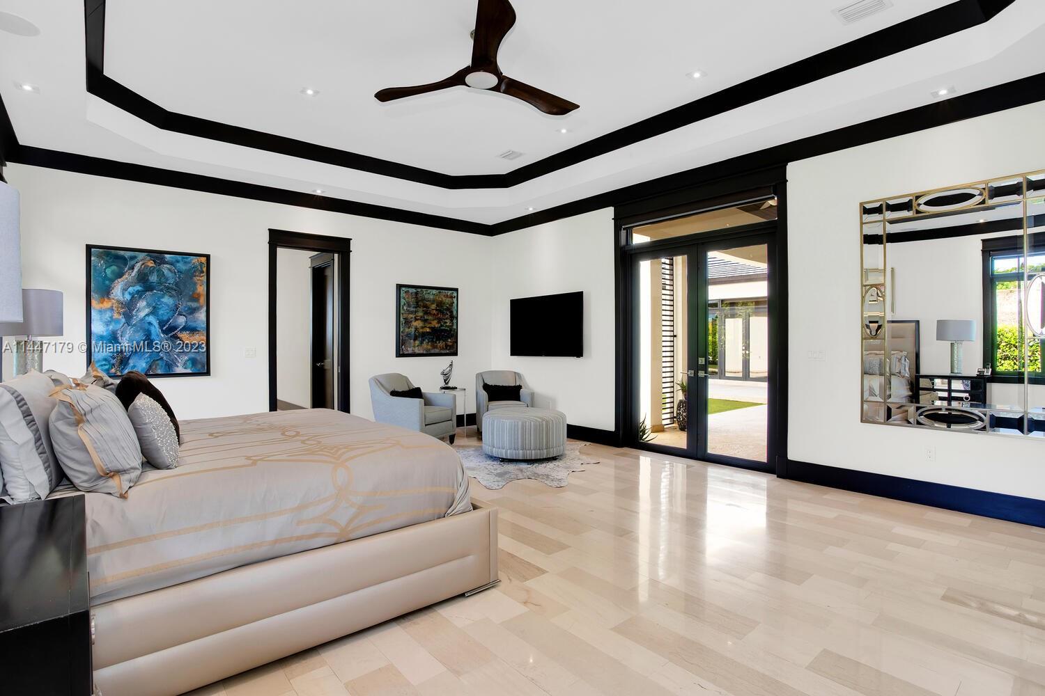 11880 Southwest 47th Street Miami, FL 33175 - Photo 24 of 61 a bedroom with a large bed and a flat screen tv